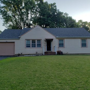 Cream ranch home with fresh exterior siding paint