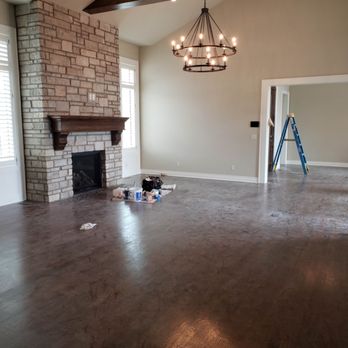 Great room with stone fireplace, chandelier and vaulted ceiling