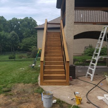 Newly built and stained exterior wood staircase to a deck