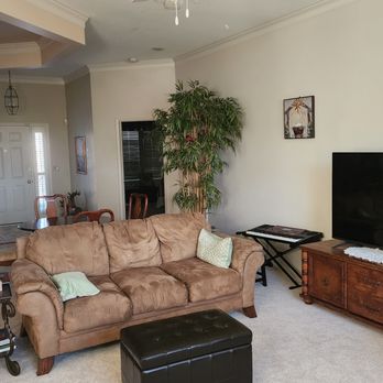 Open living room with crown molding and warm neutral walls