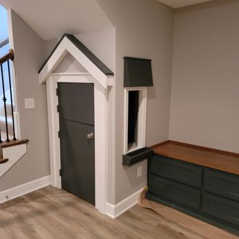 Entryway with charcoal trim and a wood-topped built-in